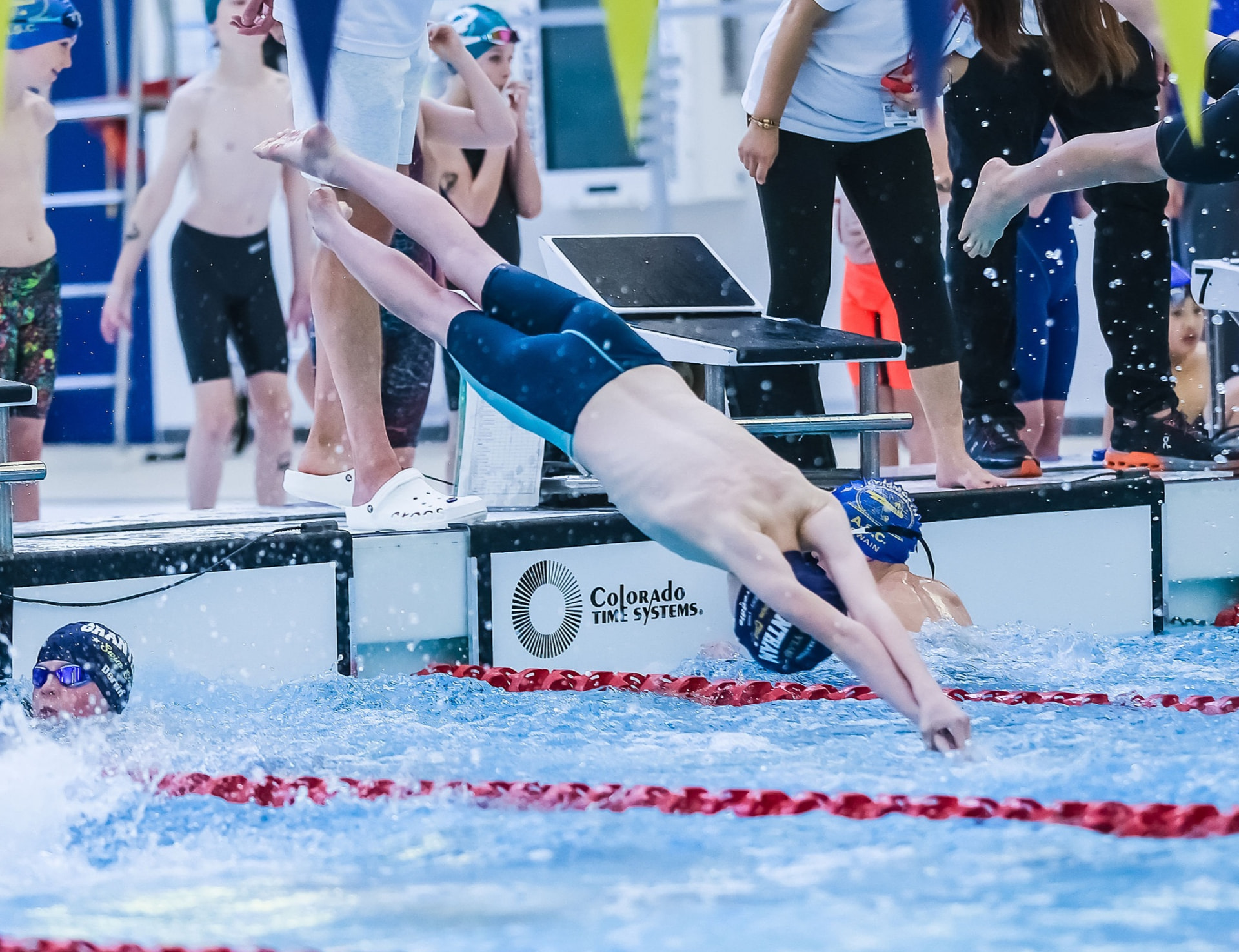 Grantham Swim Club swimmer diving into the pool at a gala